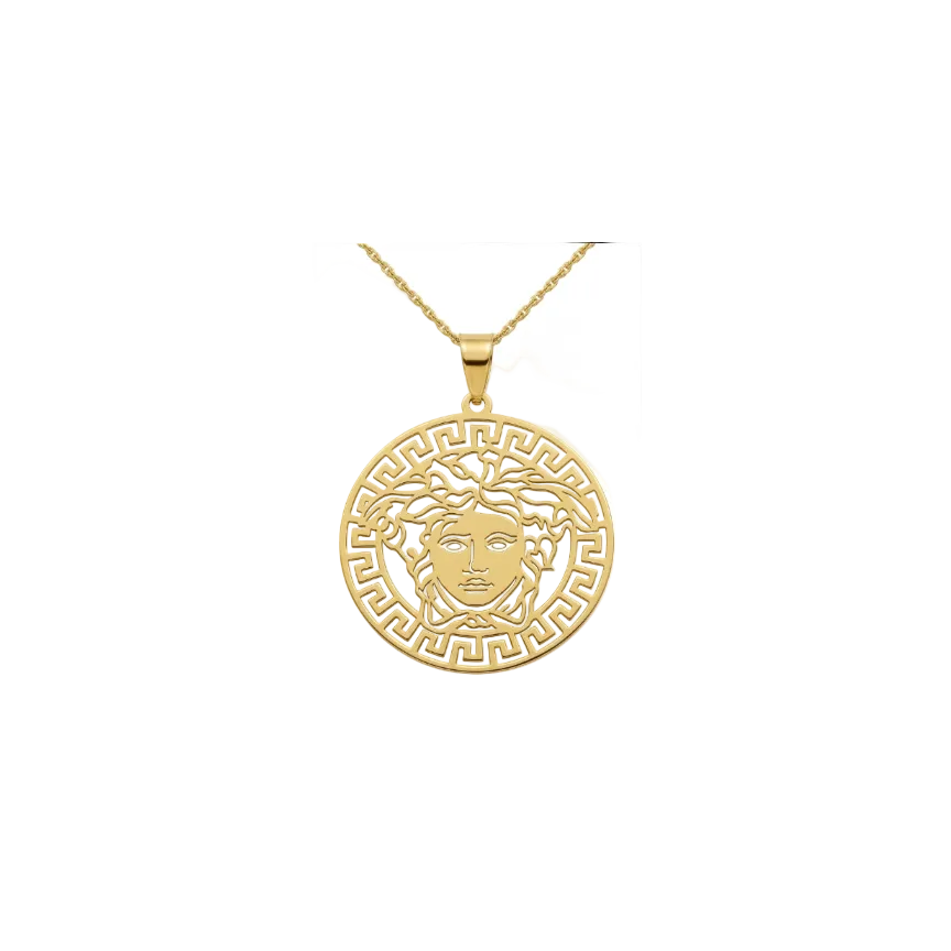 Gold pendant with a face design on a white background
