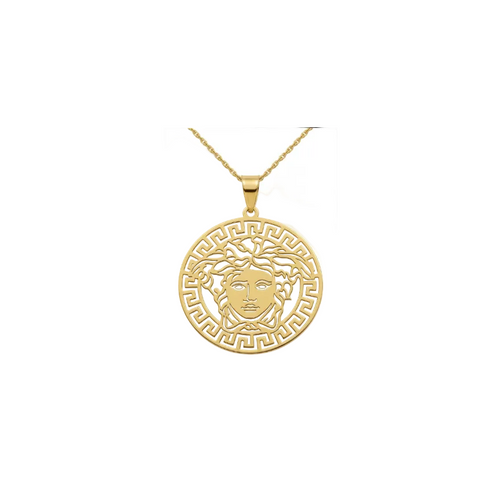 Gold pendant with a face design on a white background