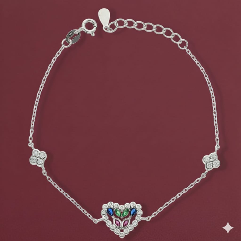 Silver bracelet with a heart-shaped clasp featuring colorful stones on a maroon background