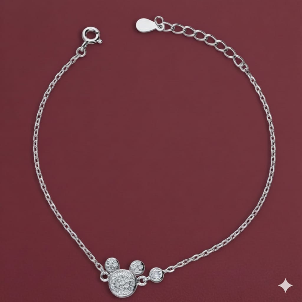 Silver bracelet with a decorative clasp on a maroon background