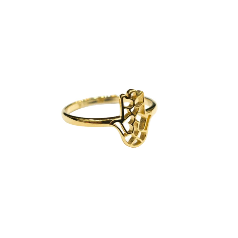 Gold ring with intricate design on a light gray background