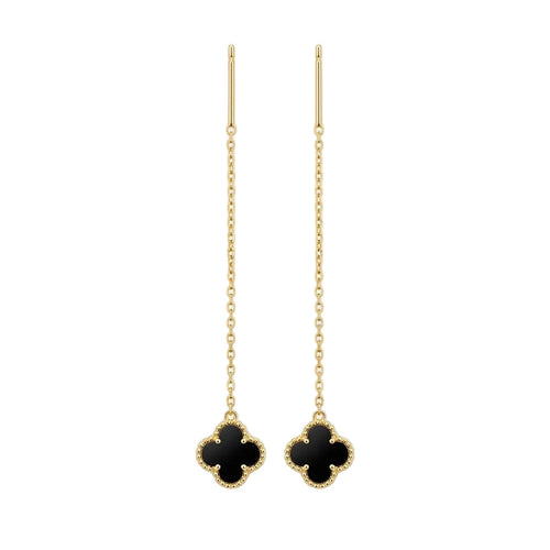 Pair of gold earrings with black clover-like charms on a white background