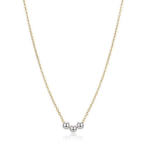 Gold necklace with three silver beads on a white background